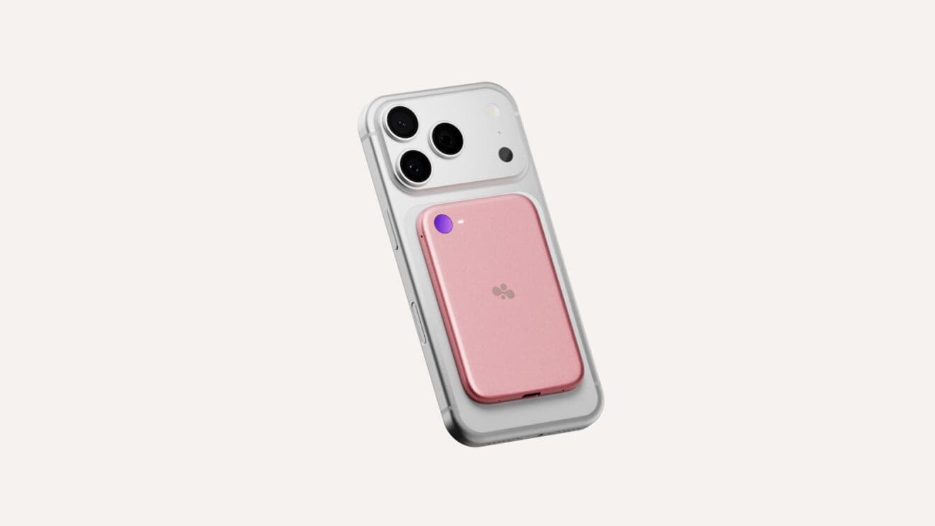 A pink Bee Eclipse device attached magnetically to the back of a white smartphone