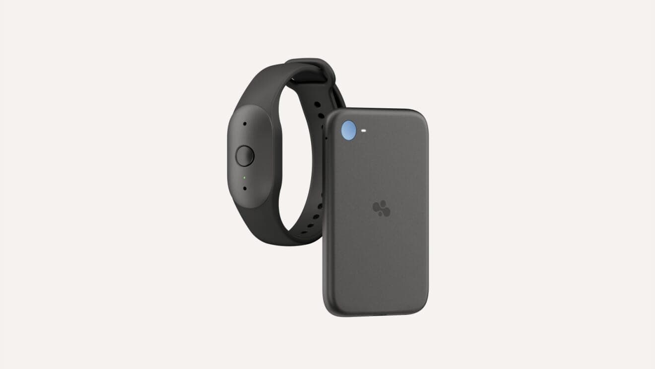 A black Bee Frontier wristband next to a black Bee Eclipse device