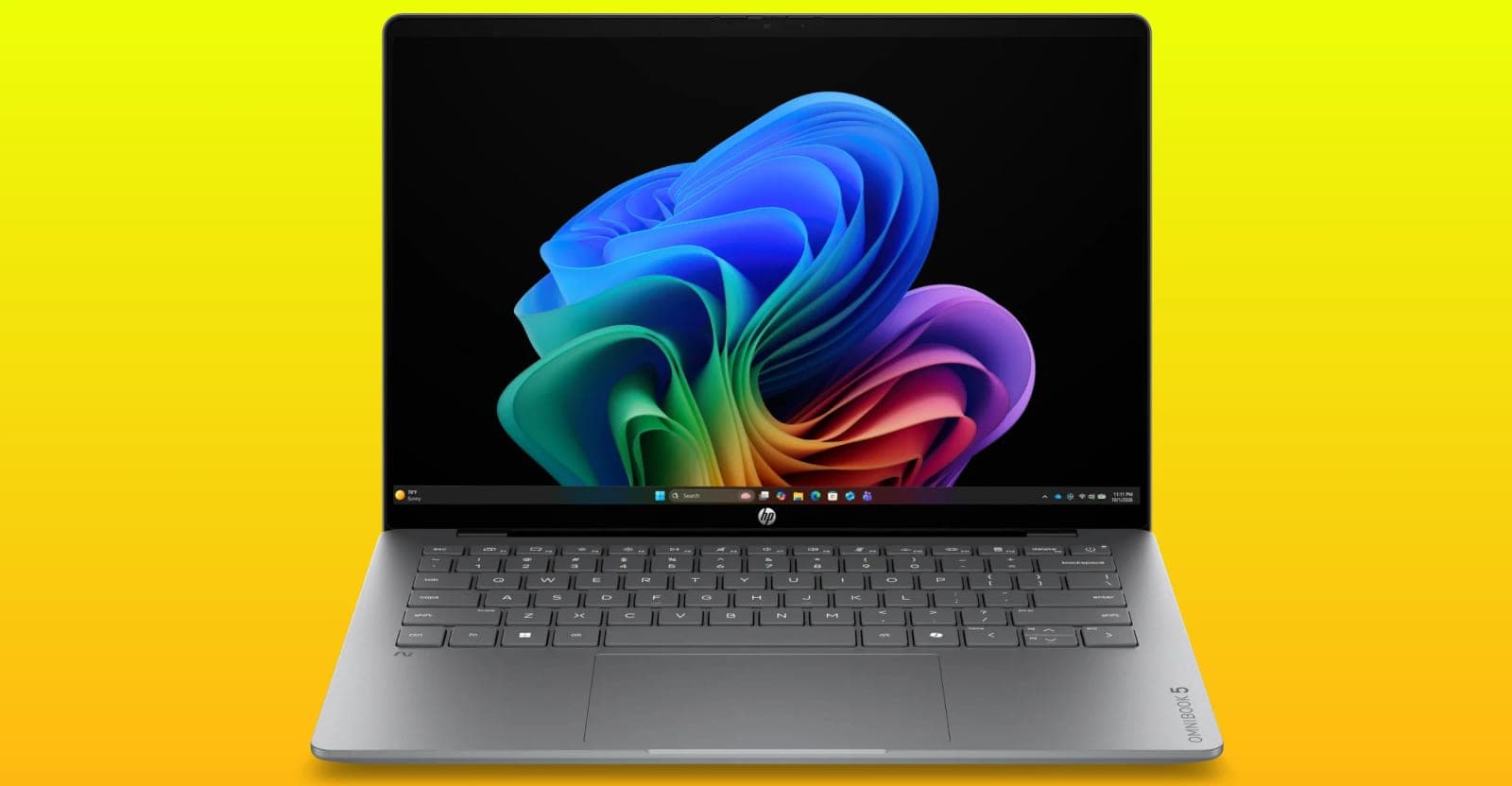 An open HP OmniBook 5 laptop displaying a colorful abstract Windows wallpaper against a yellow background