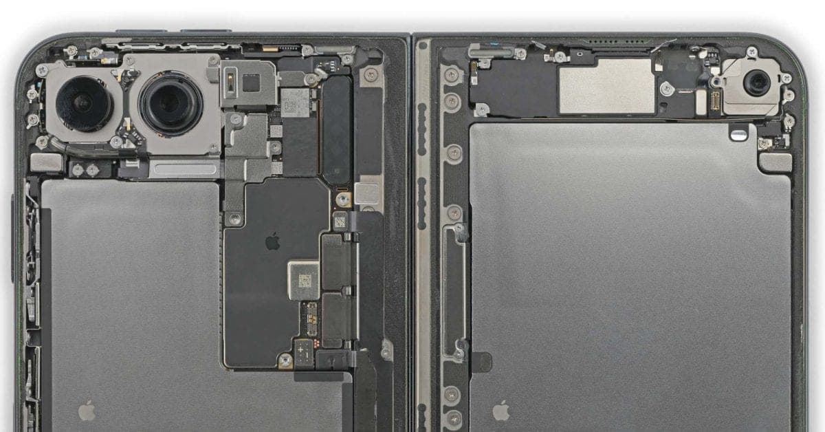 The opened iPhone Duo with its back cover removed, showing two halves with camera modules, a circuit board and two large battery cells on either side of the hinge.