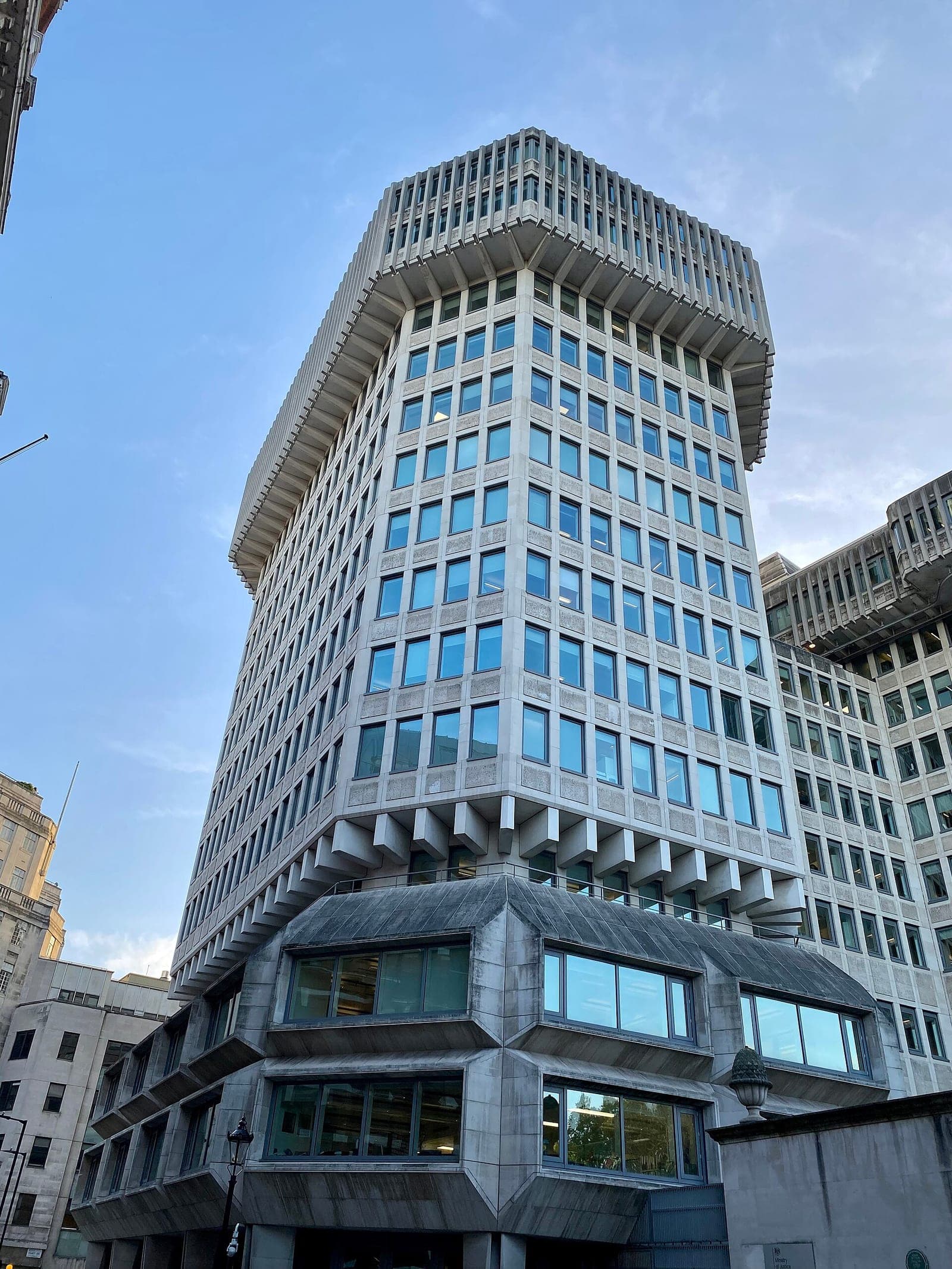 The 102 Petty France tower in Westminster, London, home of the UK Ministry of Justice, seen from street level against a blue sky