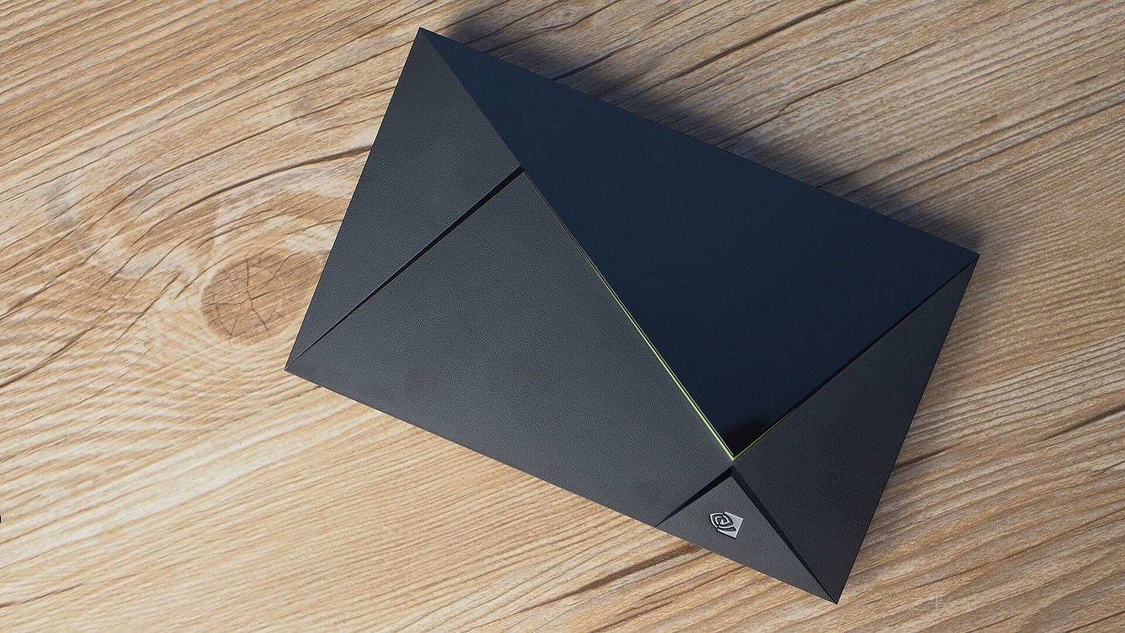 A black, angular Nvidia Shield TV streaming box, the 2017 model, lying on a light wooden table