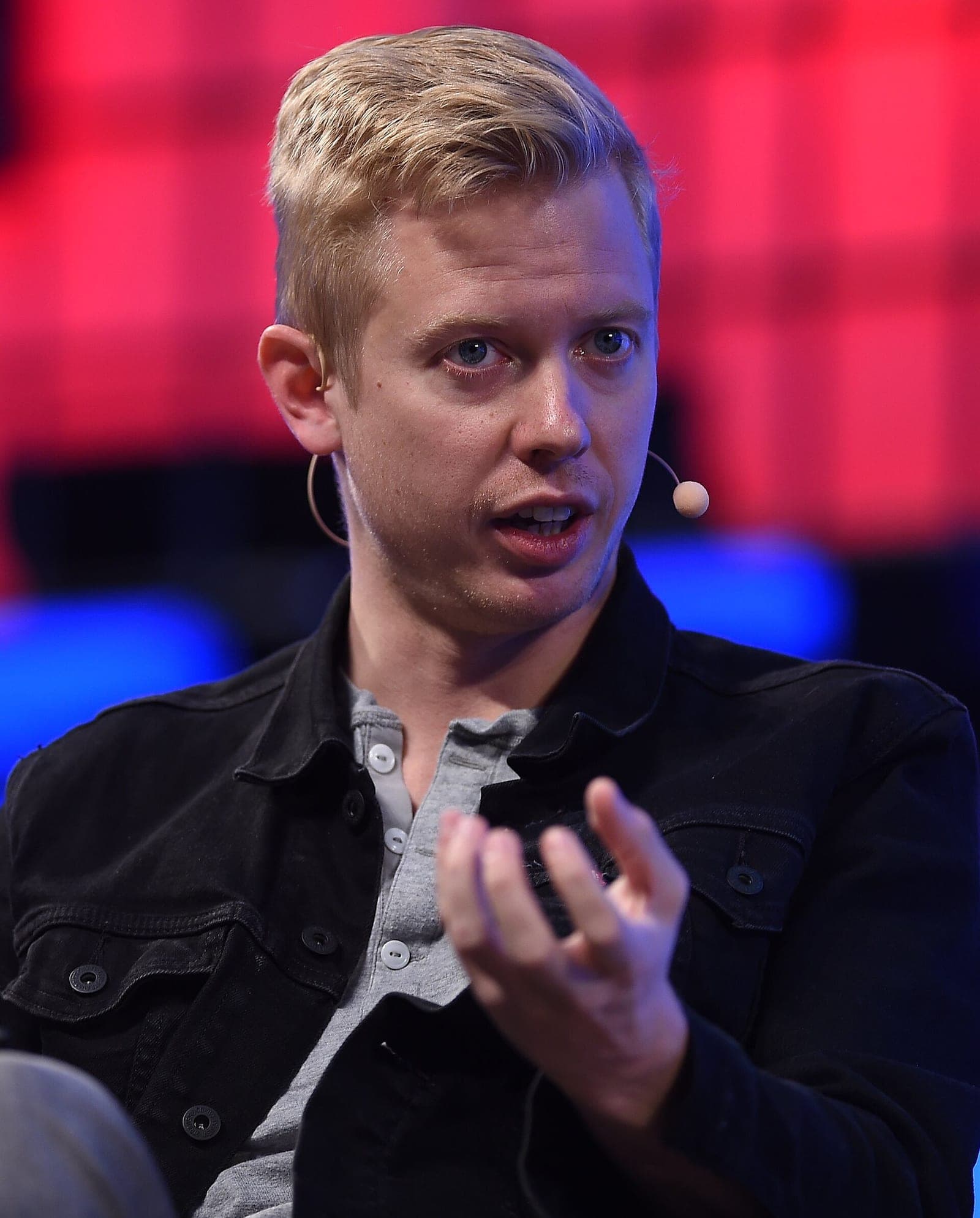 Reddit CEO Steve Huffman speaking on stage at a tech conference