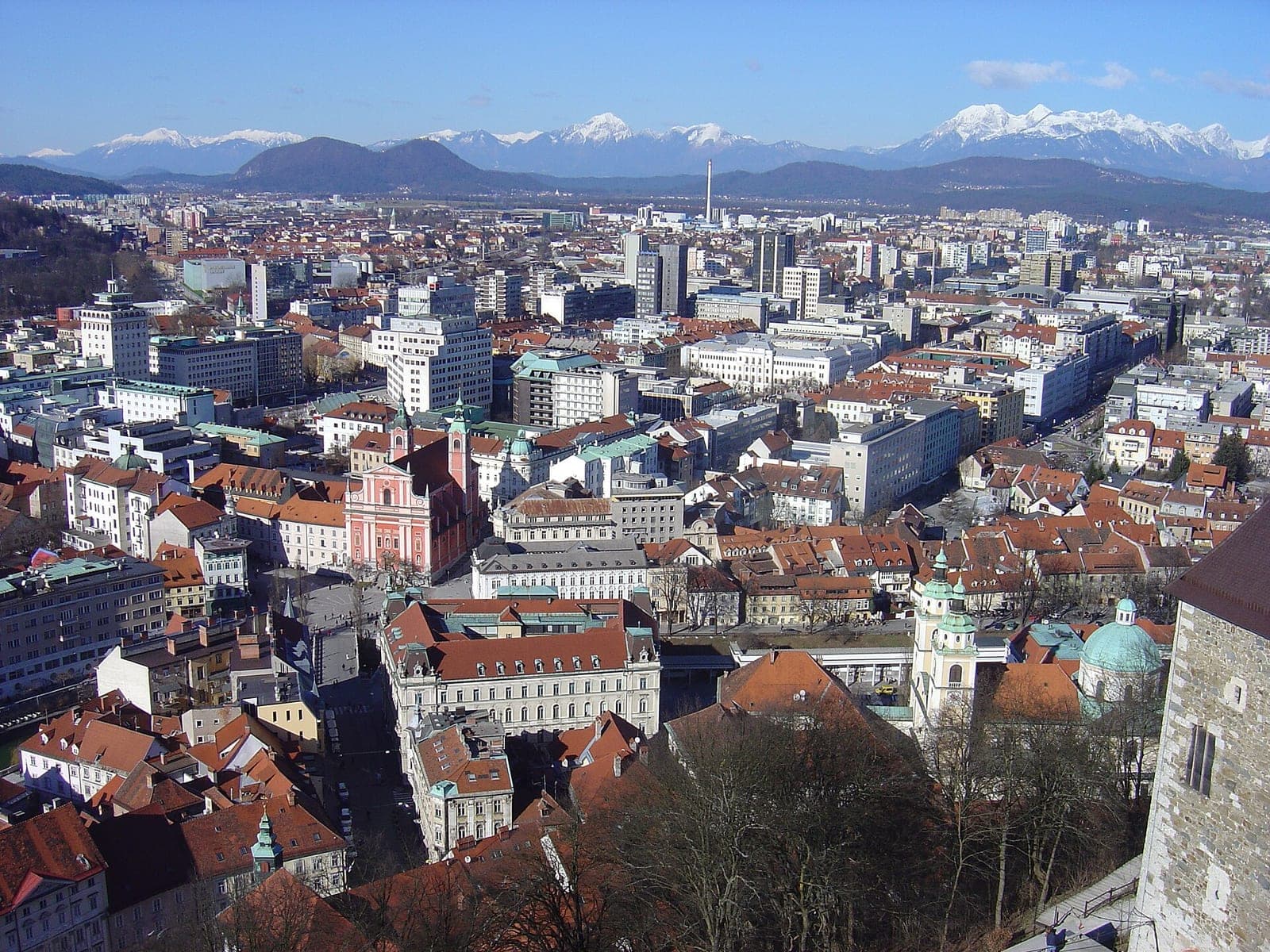 View over the red rooftops and buildings of Ljubljana, Slovenia's capital, from the castle hill, with snowy Alps on the horizon