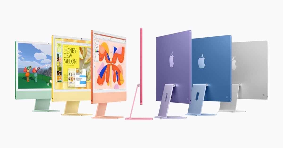 Seven 24-inch iMac computers in green, yellow, orange, pink, purple, blue and silver standing in a row