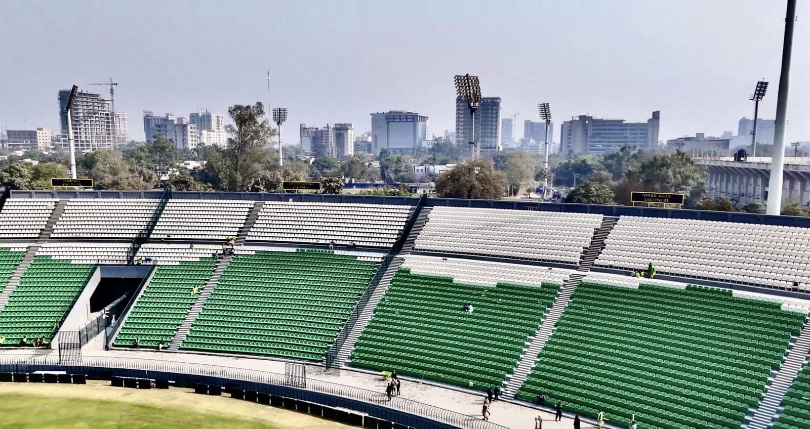 Skyline view of Lahore, Pakistan, showing city buildings behind a stadium