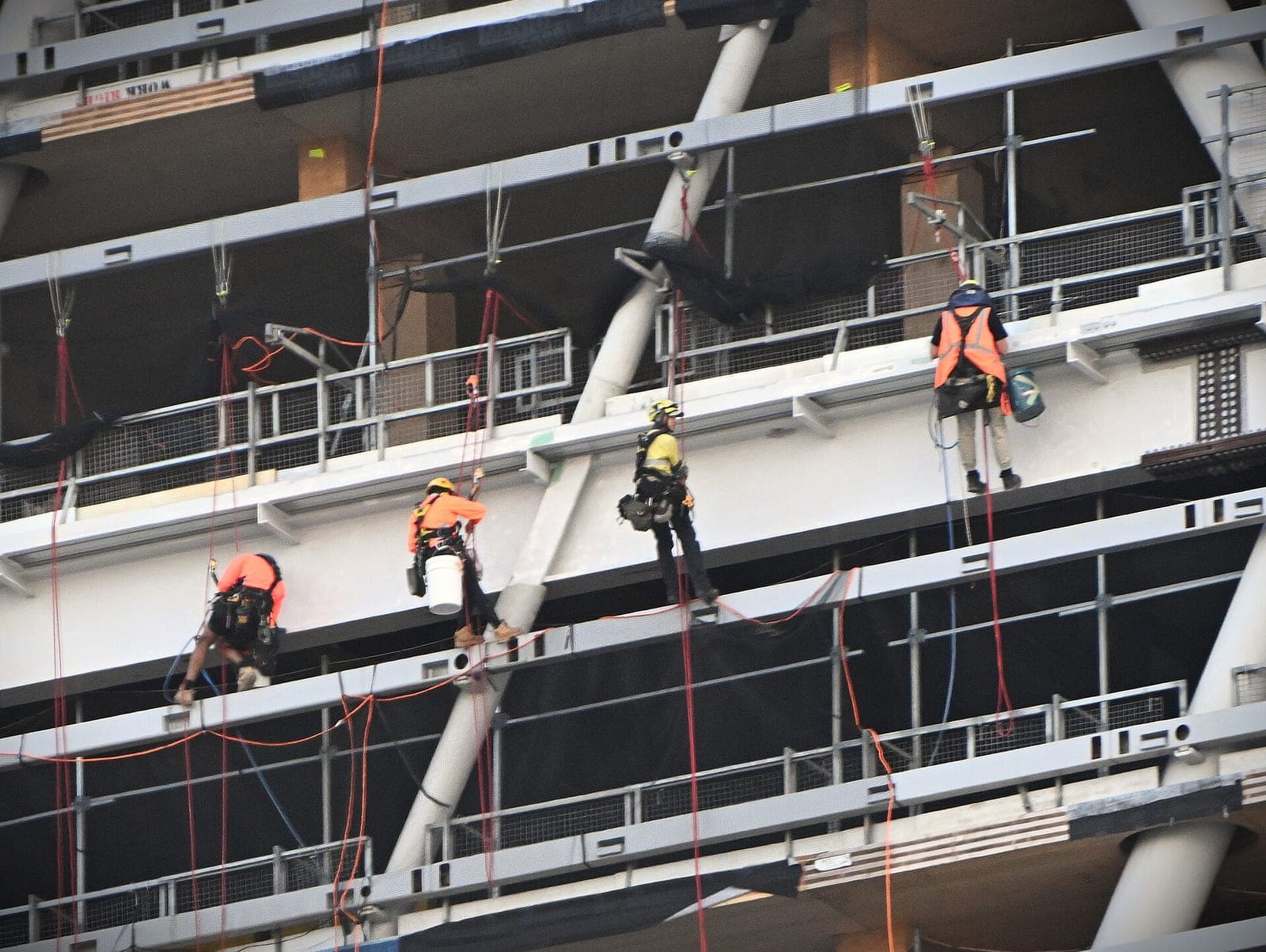 Rope-access workers on the facade of Atlassian Central, the company's headquarters tower in Sydney, during construction