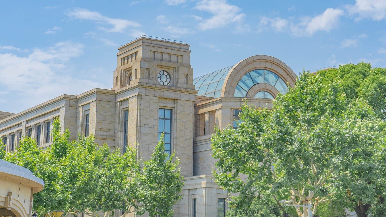 A stone academic building with a domed glass window at Fudan University's Jiangwan campus in Shanghai