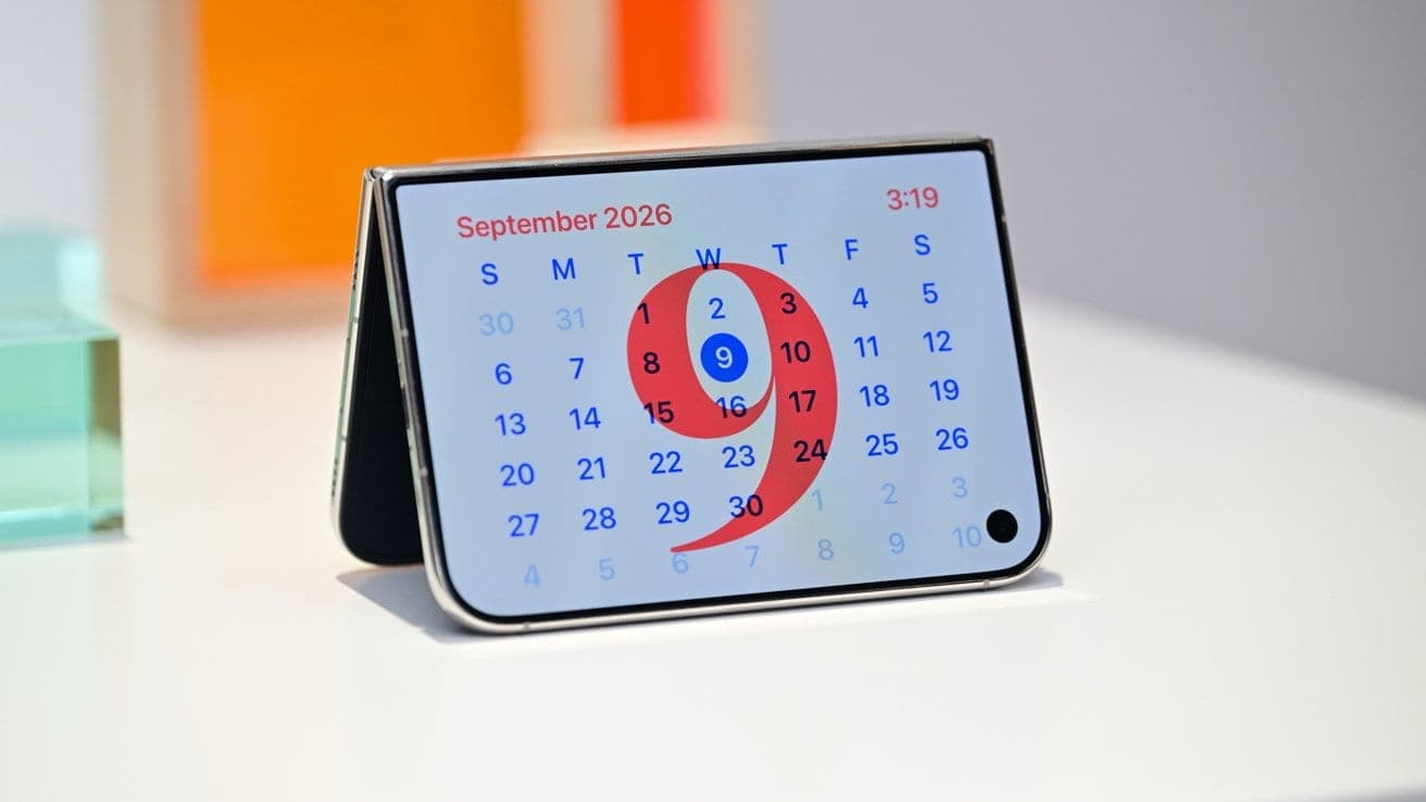 An iPhone Duo folded into StandBy mode on a desk, displaying a September 2026 calendar with the date highlighted.