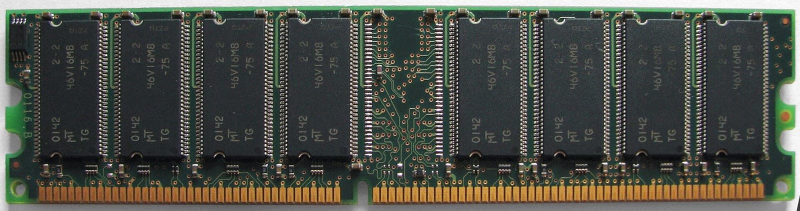 A green circuit board memory module with multiple black memory chips mounted in a row