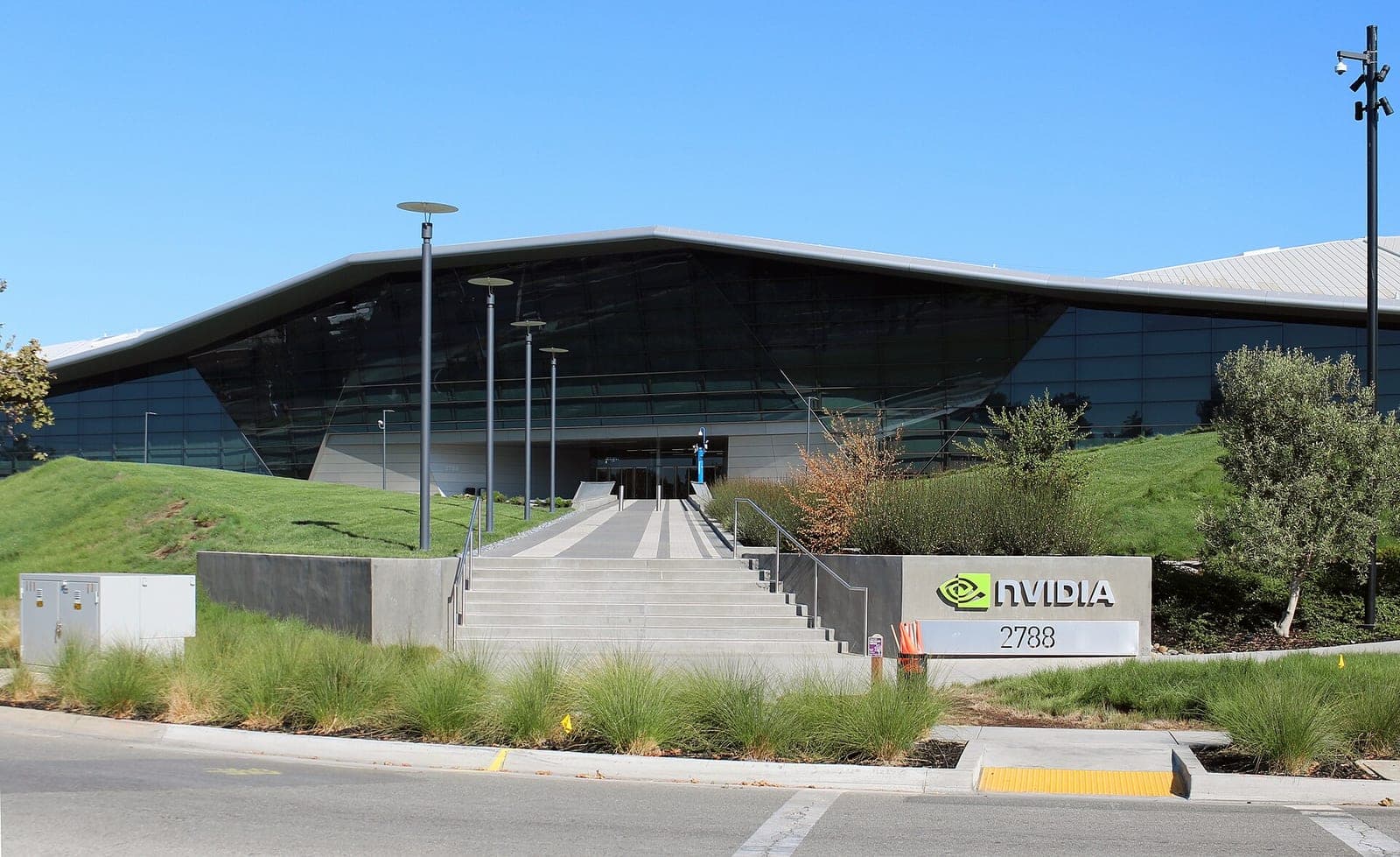Nvidia's Endeavor headquarters building in Santa Clara, California, with its angular glass facade, entry stairs and an Nvidia sign out front