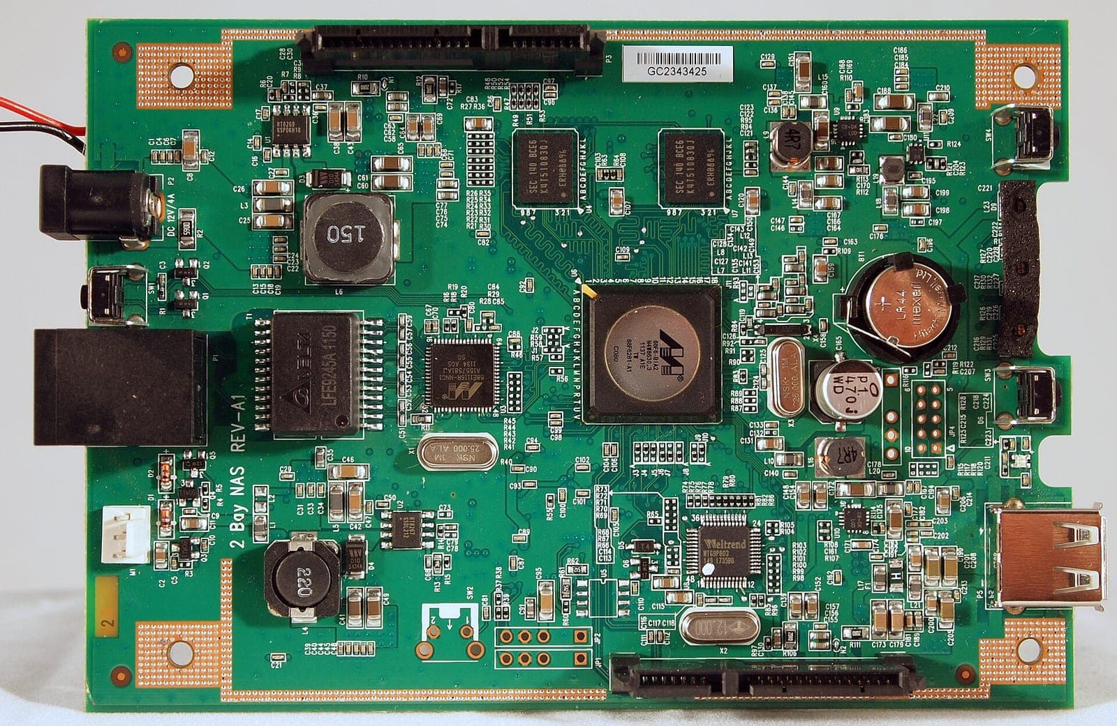The green circuit board of a D-Link ShareCenter Pulse DNS-320 two-bay network storage device, with its processor, memory chips and network port